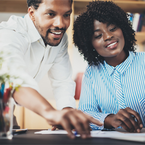 How to Invest Wisely Male and female looking at computer screen