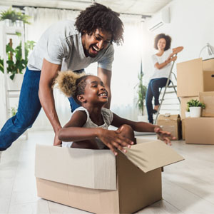 How to decide whether to sell or lease your home when relocating Happy family moving into new home