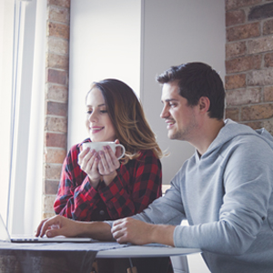 Budgeting Tips for the New Year Young couple creating budget on laptop computer