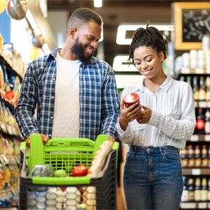 Why Your Grocery Bill is Too High and How to Lower it Couple grocery shopping together