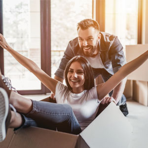 How to decide whether to sell or lease your home when relocating Couple moving into new home